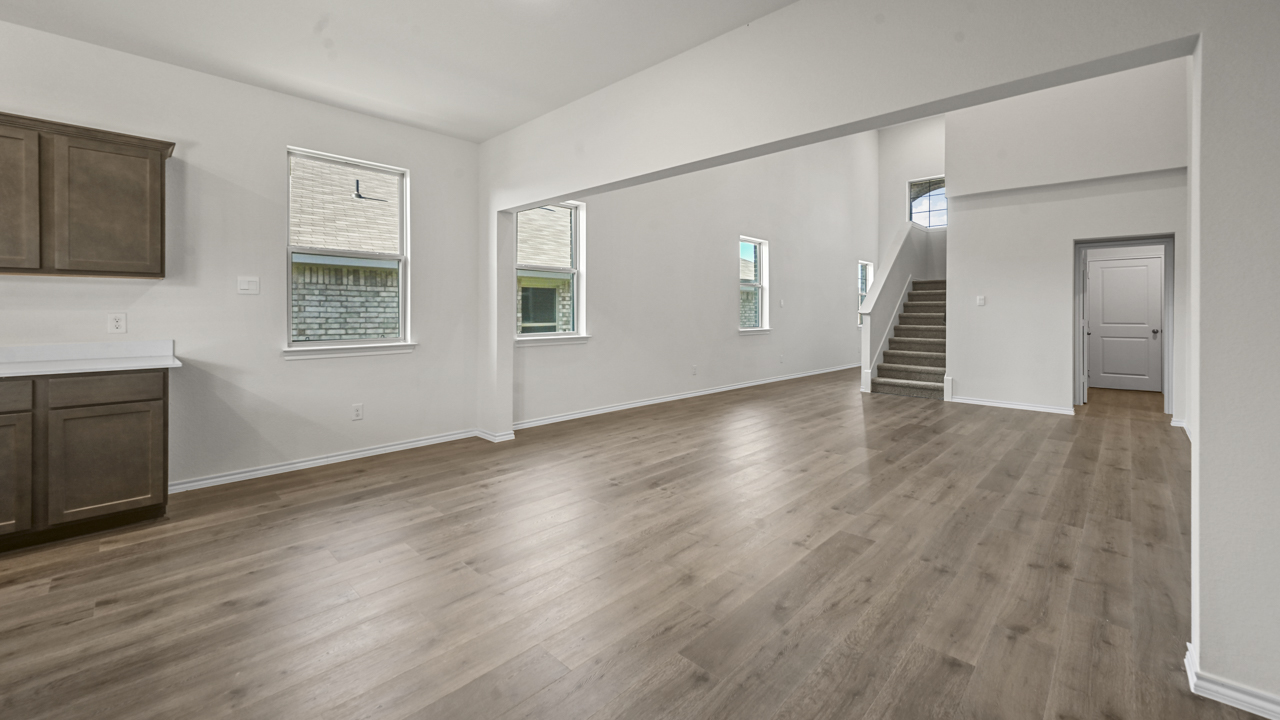 the open living area with white walls and wood floors