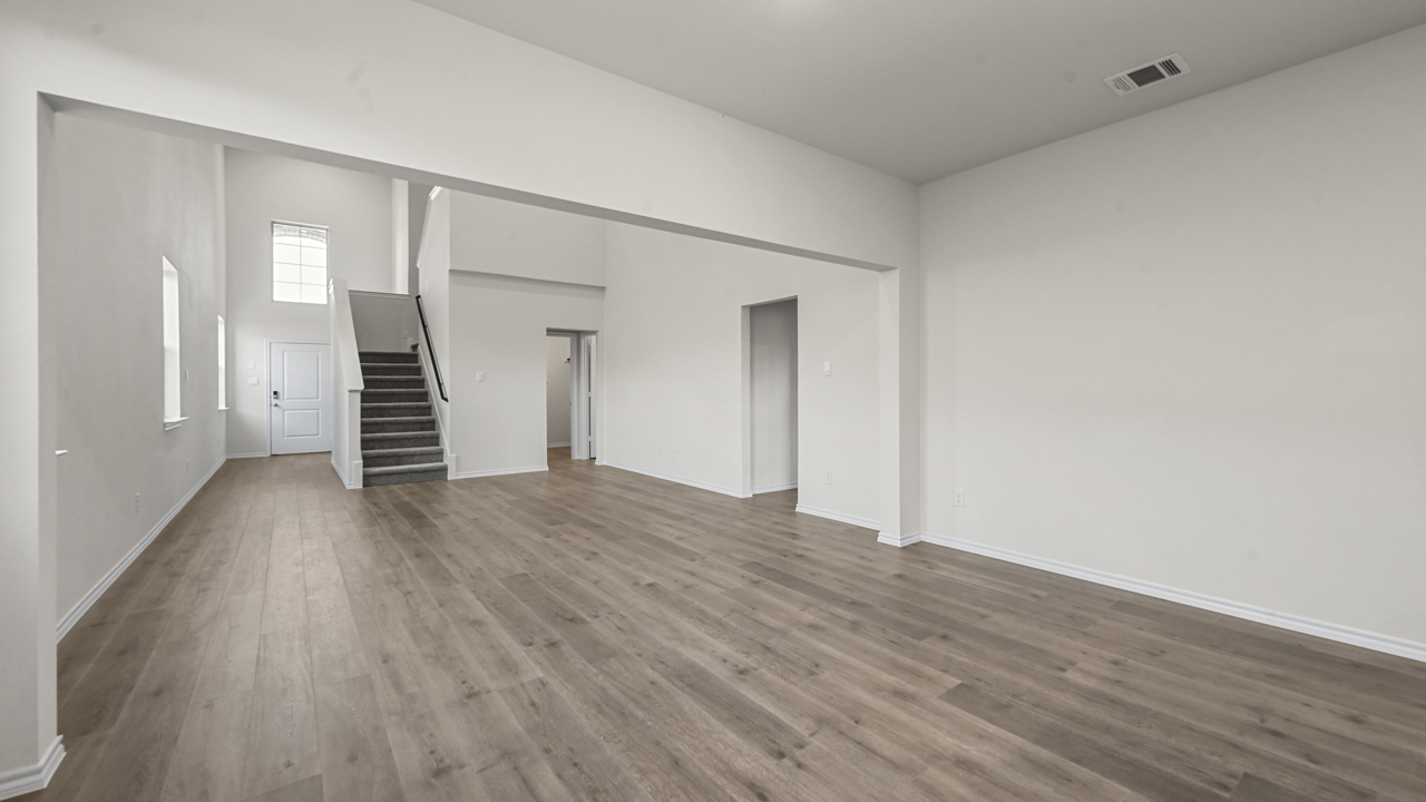 the open living area with white walls and wood floors