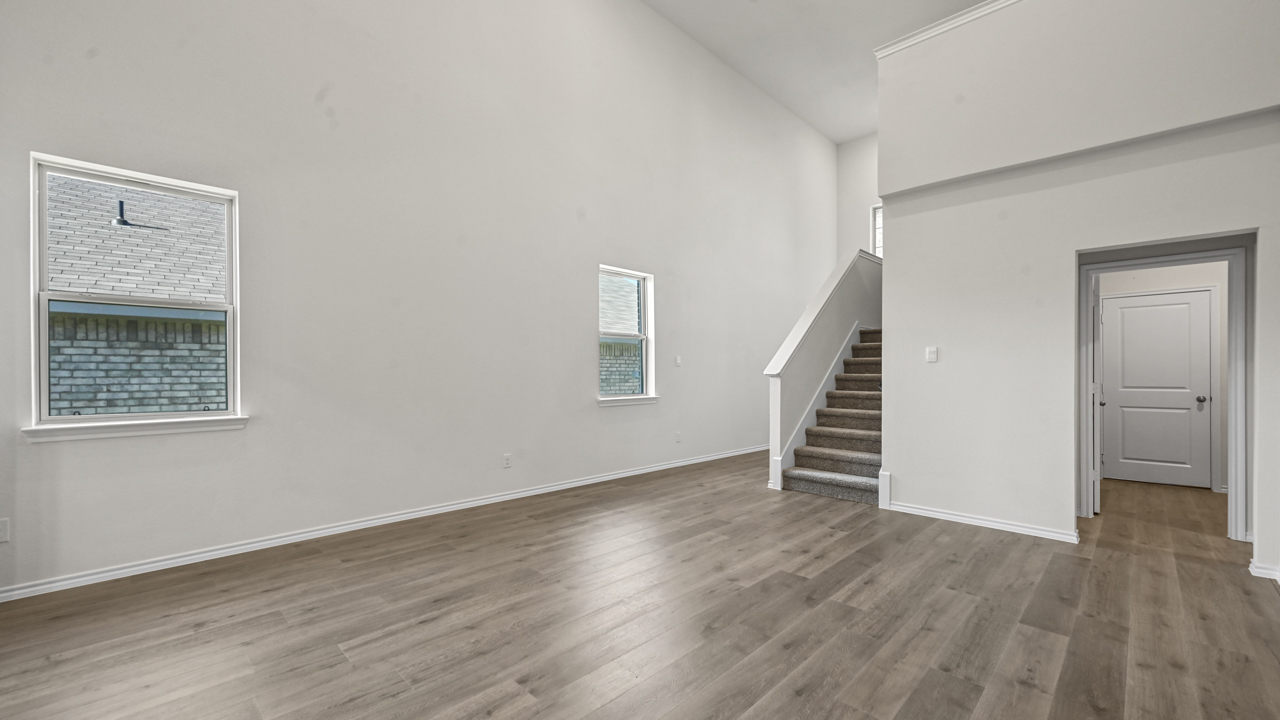 the open living area with white walls and wood floors