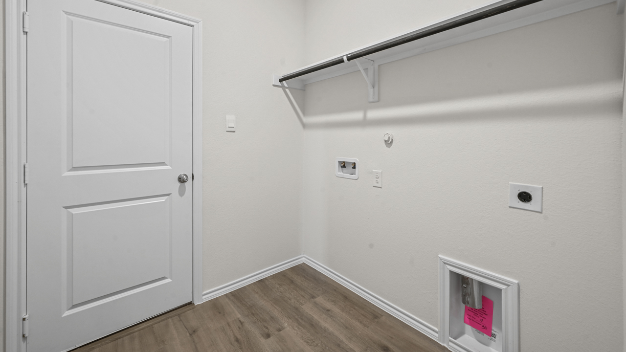 an empty closet with space and hookups for a washer and dryer