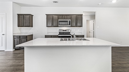 X30B kitchen with white countertops and dark cabinets