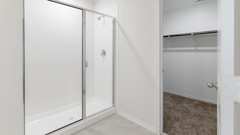 X30D primary bathroom with view of the closet and shower