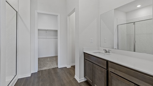 X30F primary bathroom with view of closet and shower