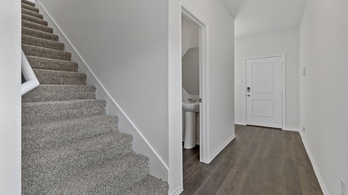 X30F staircase with view of powder room and interior entrance