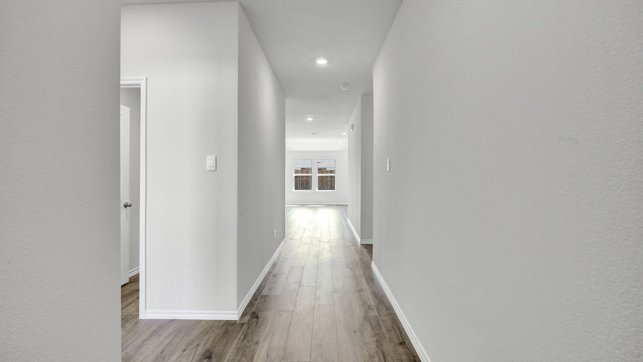 Interior entrance with hardwood floors leading to the open concept living area