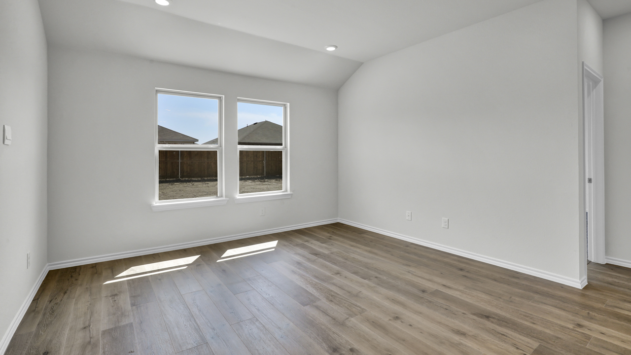 Open concept living area with hardwood floors and large windows providing natural light to the living space