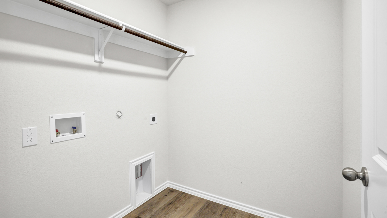 Utility area for washer and dryer with hardwood floors