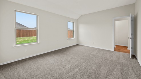 X40C primary bedroom with carpet and natural light