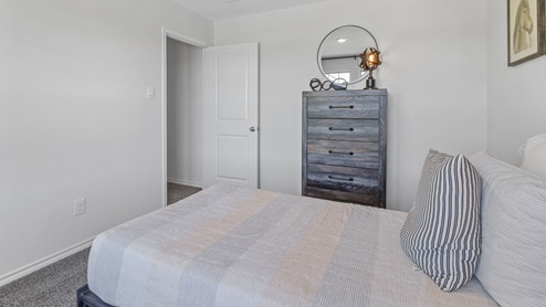 Furnished bedroom with two windows and closet