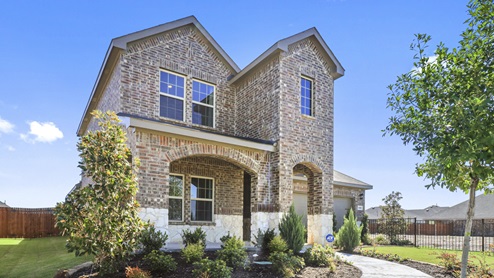Two story model home with covered patio and beautiful landscaping