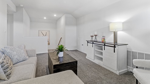 Upstairs media room with windows and furnishings