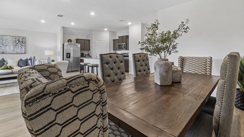 Dining area with table and chairs and views into living room