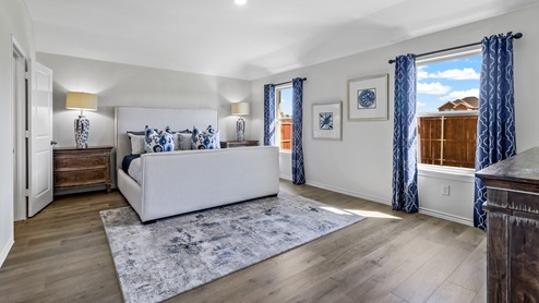 Large primary bedroom with large windows