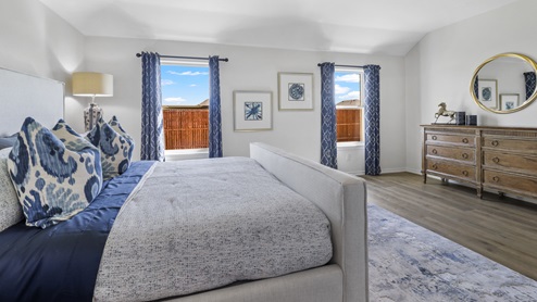 Large primary bedroom with large windows