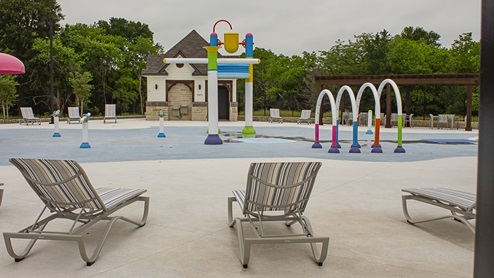 Stonehaven swimming pool, splash pad and lounge chairs