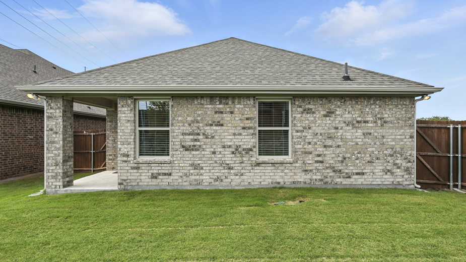 rear exterior of home featuring a spacious fenced in backyard