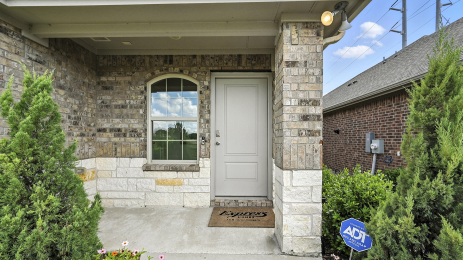.front exterior of a home with stone exterior and brown siding