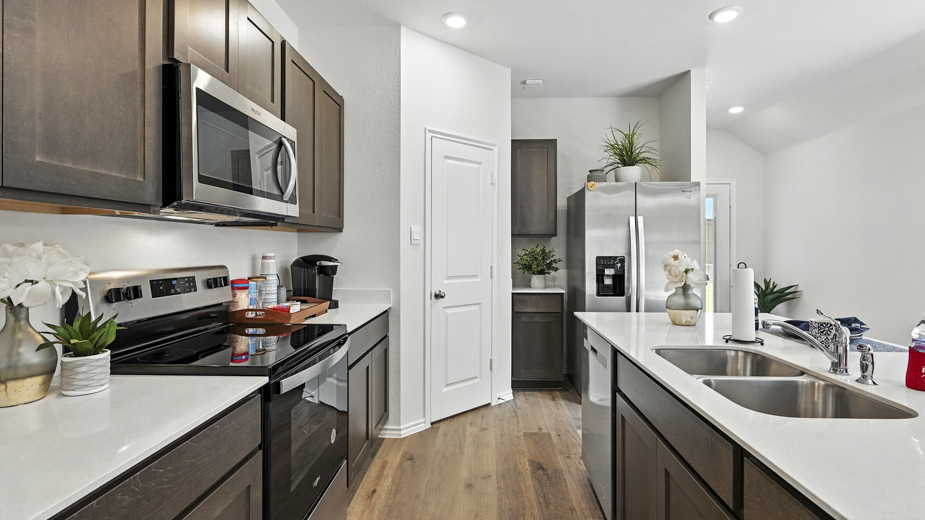 kitchen with brown cabinetry, large island and stainless steel appliances
