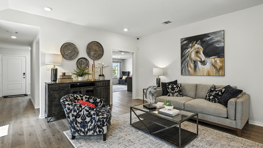 living room with a grey sofa, coffee table and an accent chair