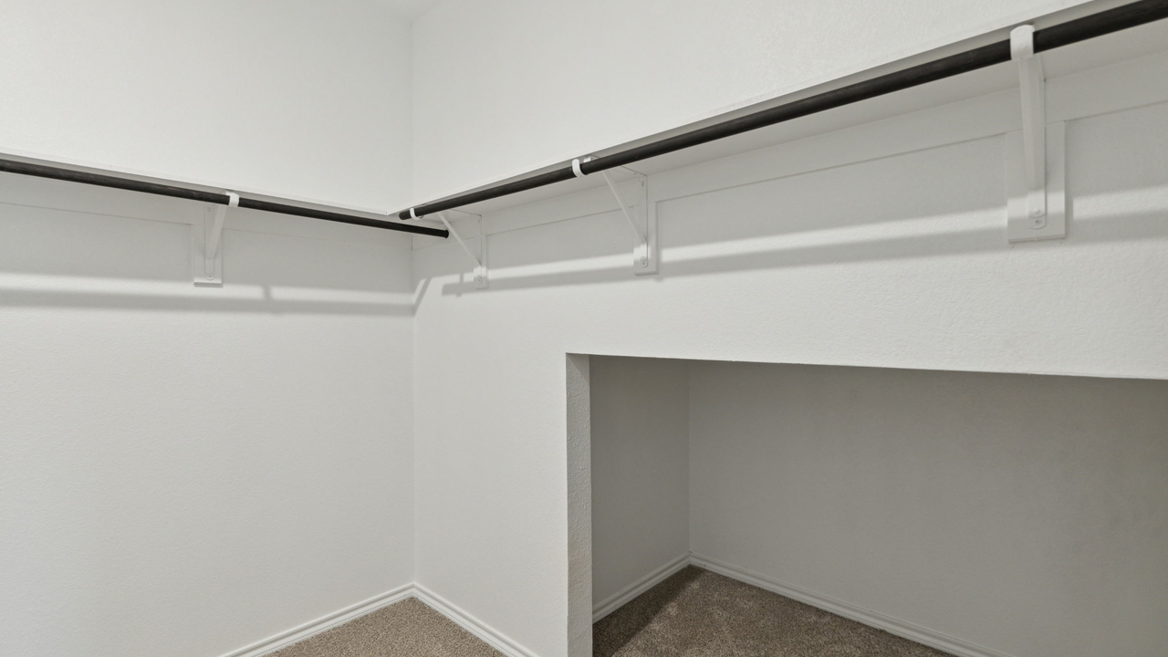 large walkin closet with hanging rods and storage area