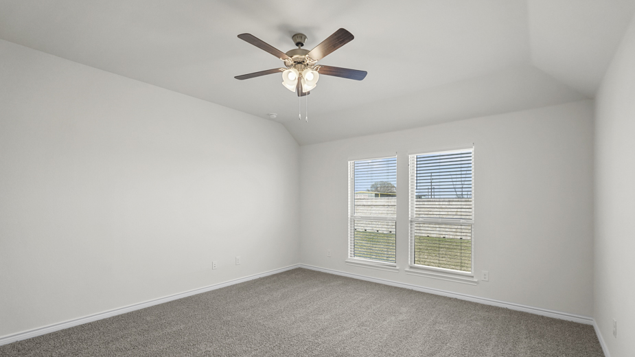 primary bedroom with large windows facing the backyard