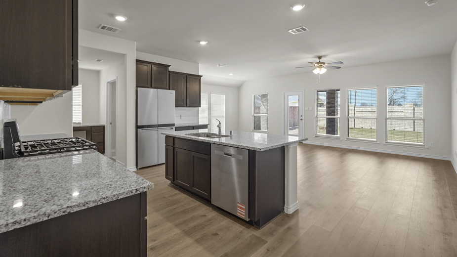 kitchen area with hardwood floors dark cabinets and light colored counters