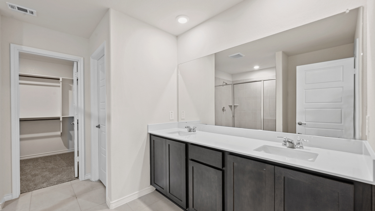 primary bathroom with dark brown cabinets