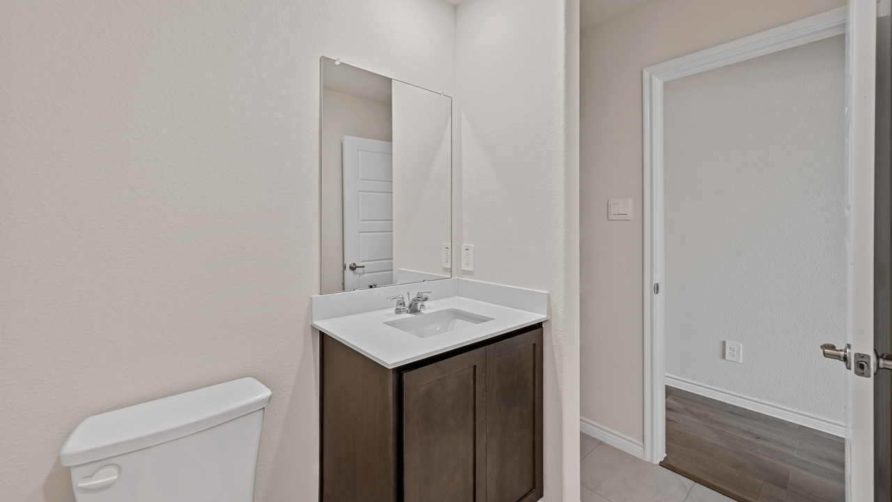 bathroom with brown cabinet