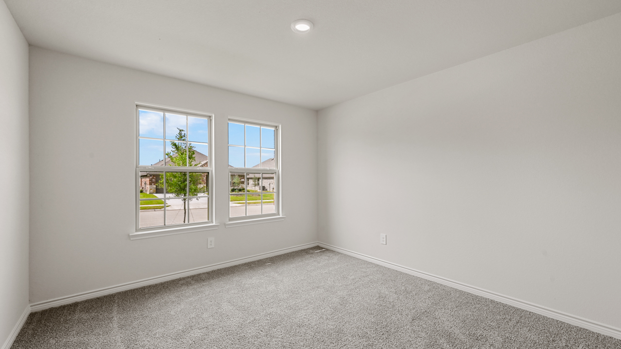 bedroom with gray carpet and window