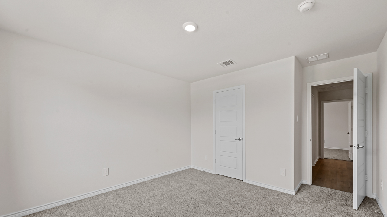 open bedroom with gray carpet