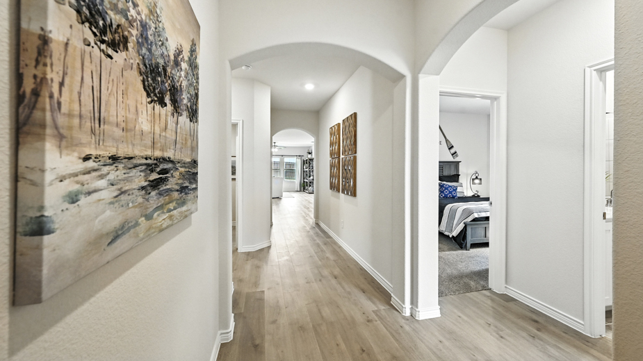 entry hallway featuring brown flooring and white walls