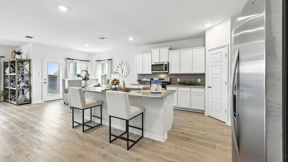 kitchen with white cabinetry, large island and stainless steel appliances