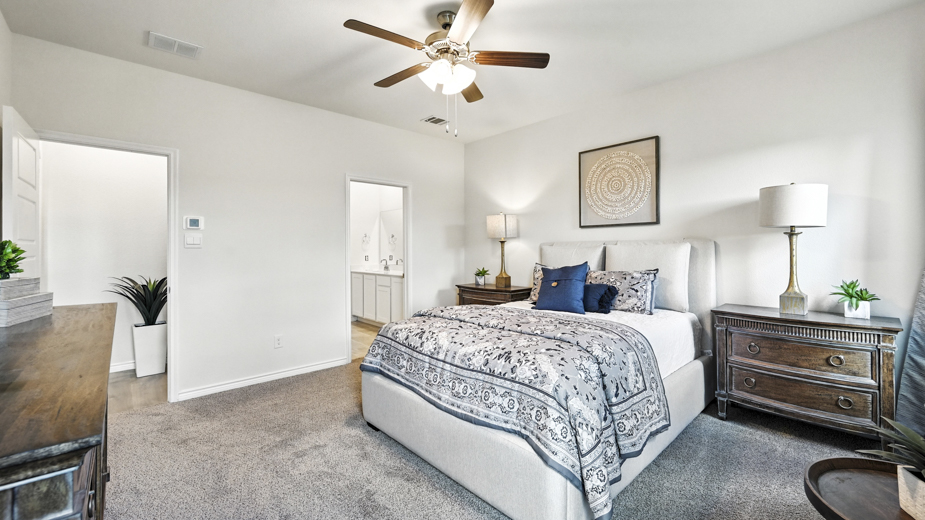 primary bedroom with a bed with night stands on either side