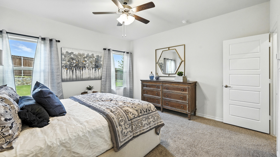 primary bedroom with a bed with night stands on either side