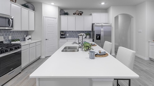 H229 kitchen area with white countertops and cabinets