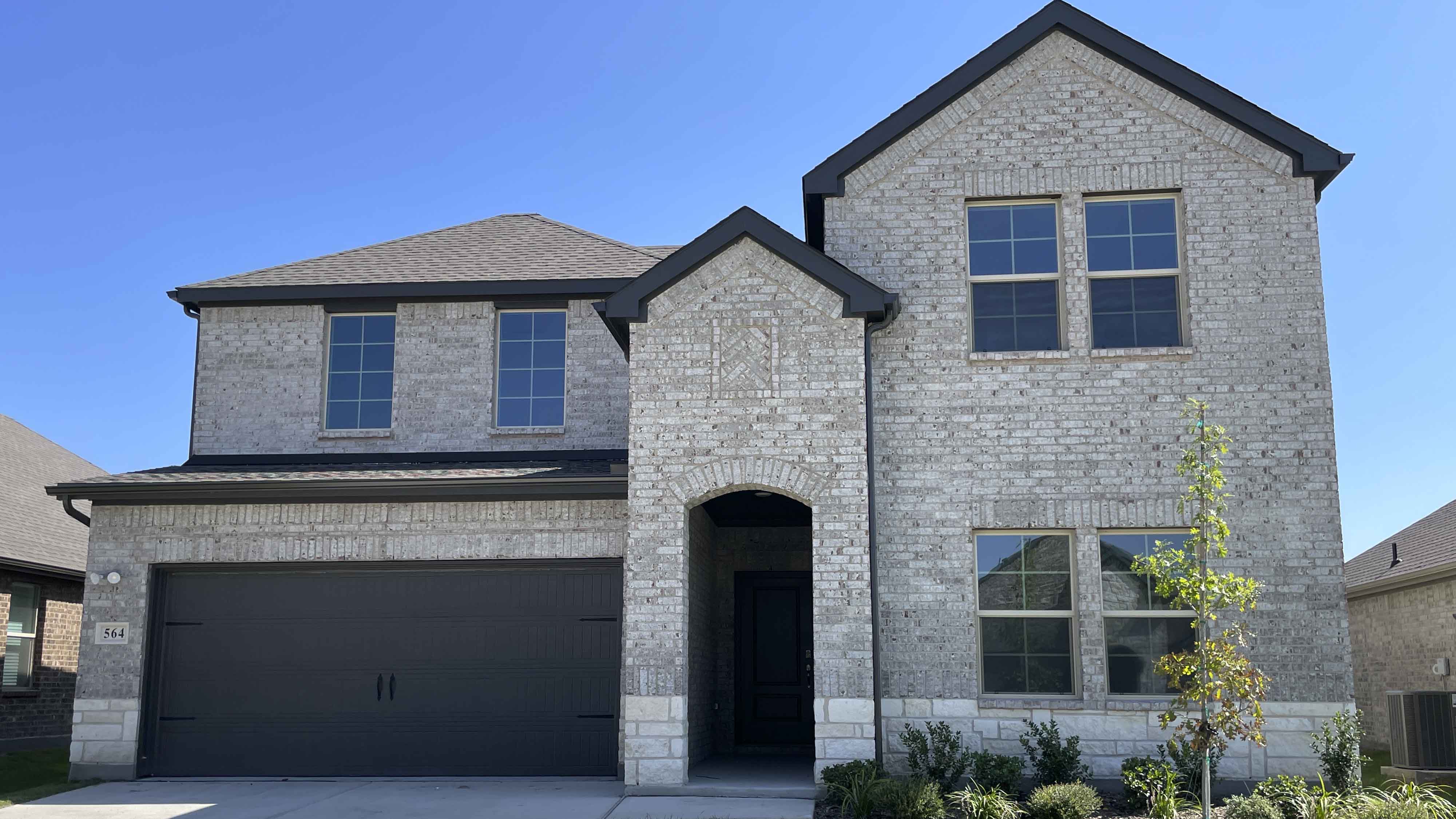 two story home with brick and stone exterior