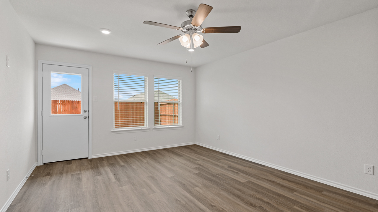 living area with window and wood flooring