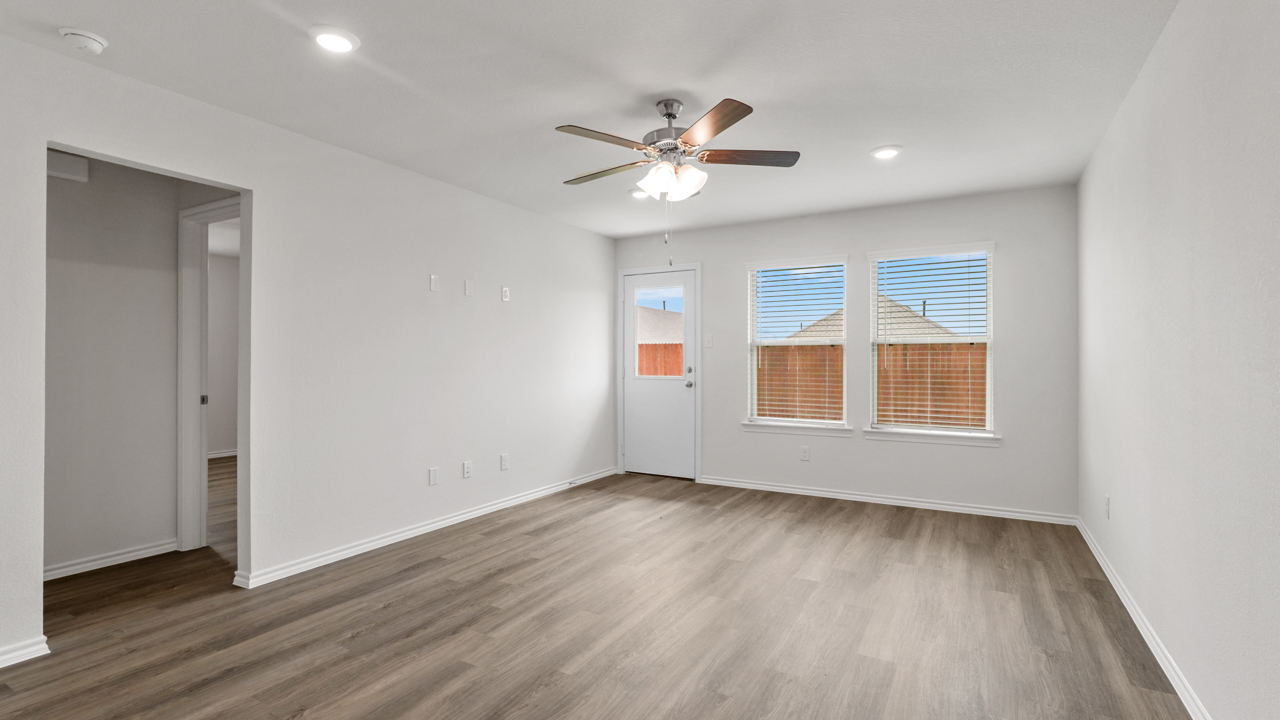 living area with window and wood flooring