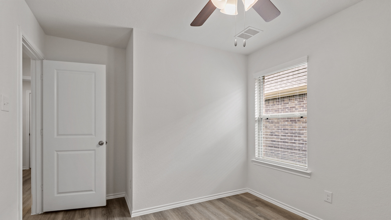 bedroom with wood floors and a window
