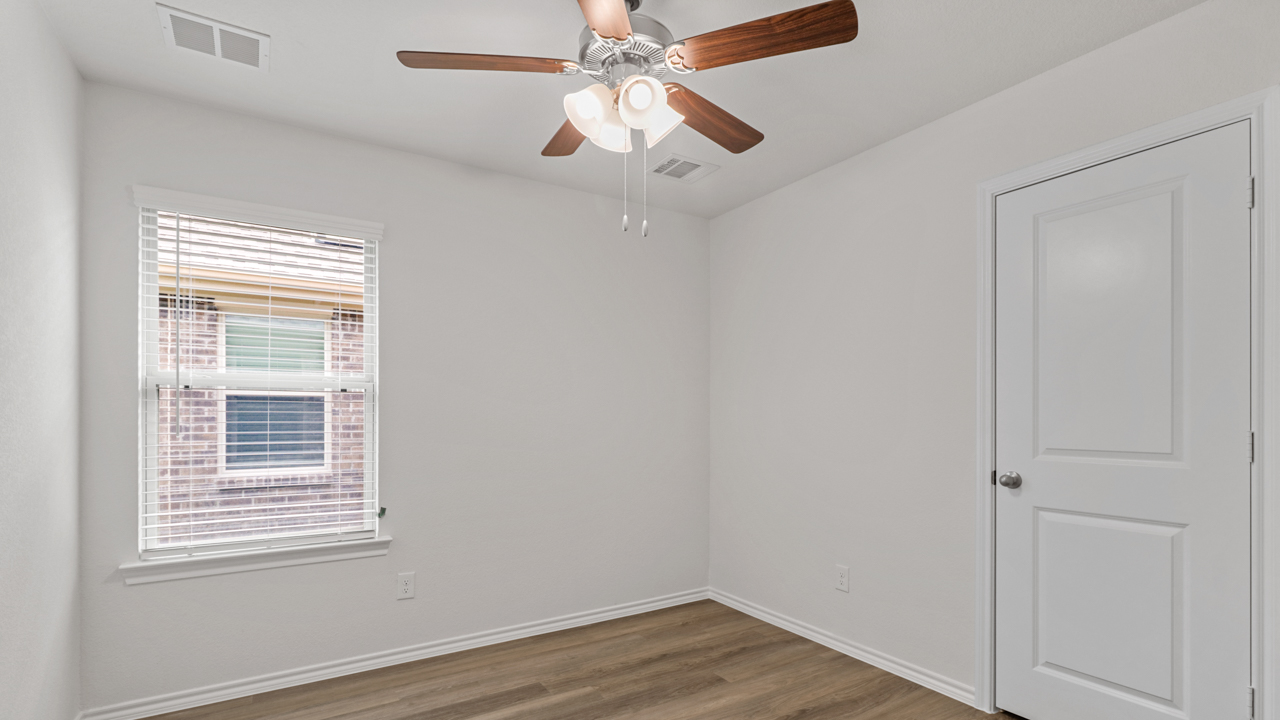 bedroom with window and ceiling fan