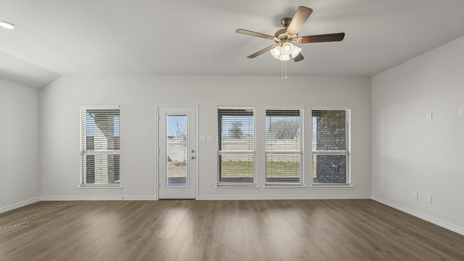 living room with open windows and wood floors