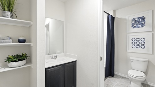 Bathroom featuring built in shelving and a walk in shower.