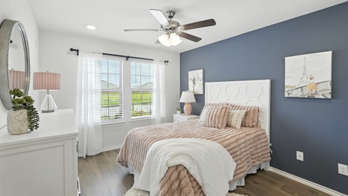 Bedroom with an accent wall and natural lighting.