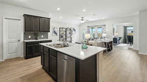 Spacious kitchen with brand new stainless steel appliances connecting to the living area.