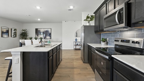 Kitchen featuring brand new stainless steel appliances, cabinets, and a large island.