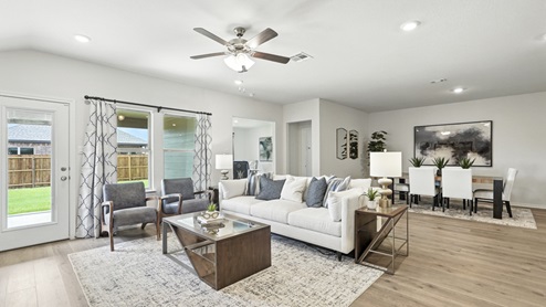 Living area with simple furnishings and an area rug.
