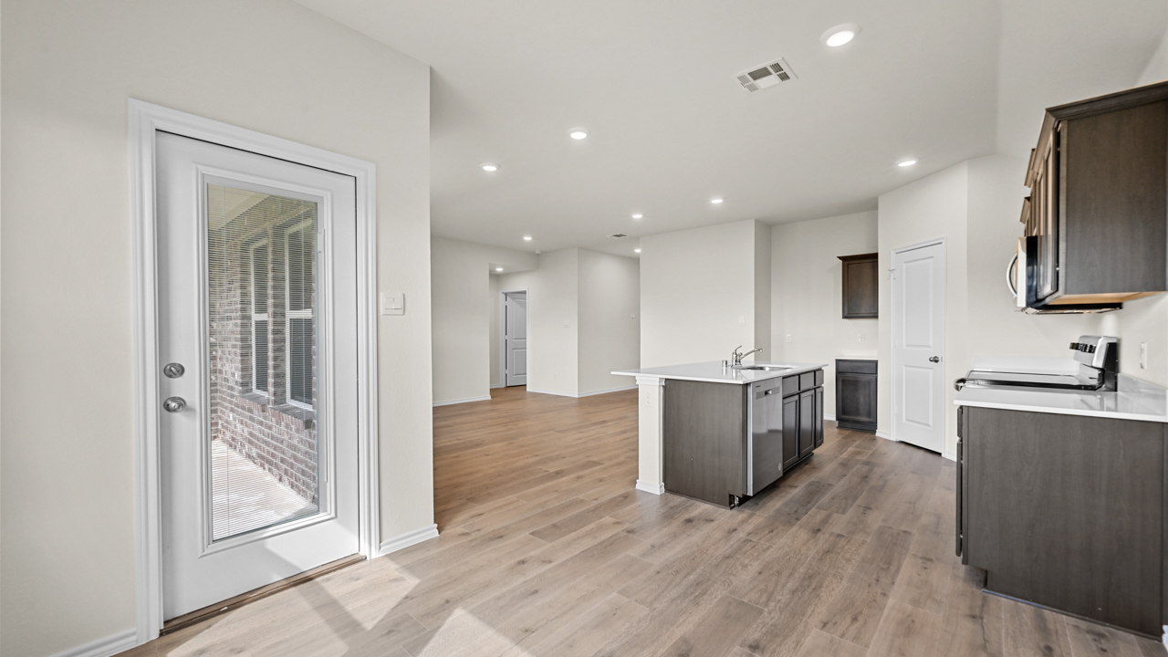 and open dining space with windows and wood floors