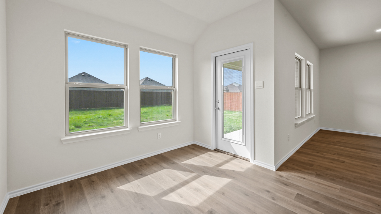and open dining space with windows and wood floors