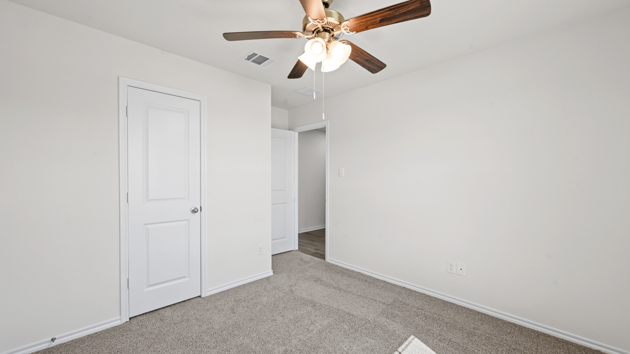 an open bedroom with gray carpet