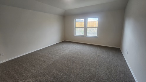X50F primary bedroom with carpet and natural lighting